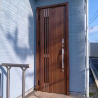 無機質なアルミドアが木目調に！温もりと高級感をプラスする玄関ドアリフォーム【埼玉県久喜市の事例】